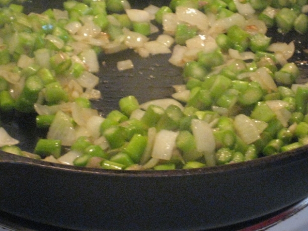 sauteeing asparagus, onions, and garlic in olive oil